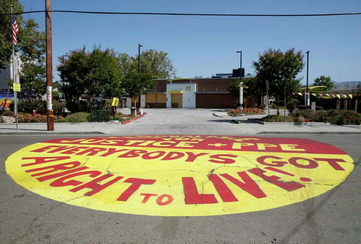 A message was painted on 45th Street in front of a McDonald’s in Oakland in July, after employees contracted COVID-19.