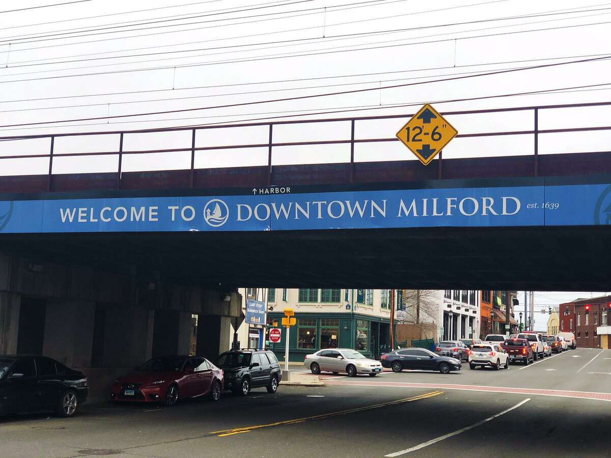 A sign on a bridge marking downtown Milford.