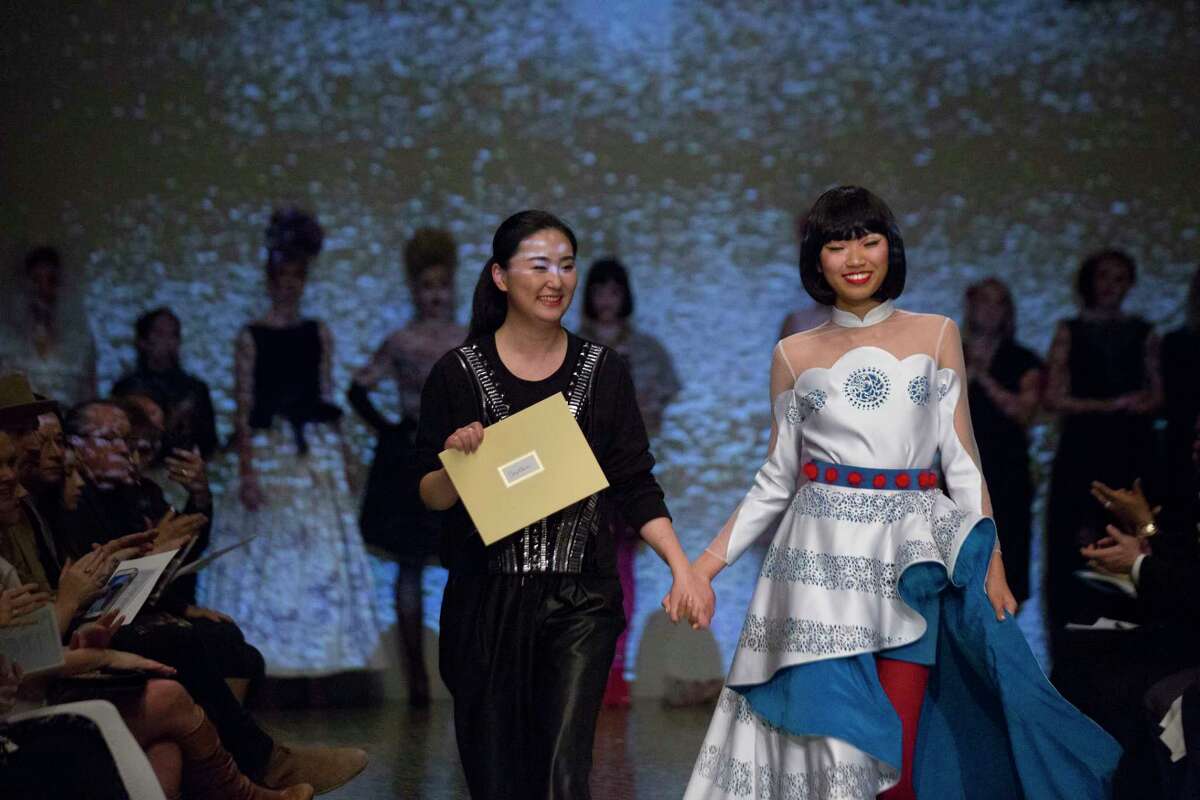 Jing Cao walks next to her creation at Fashion Fusion, Thursday, Jan. 11, 2018, in Houston.
