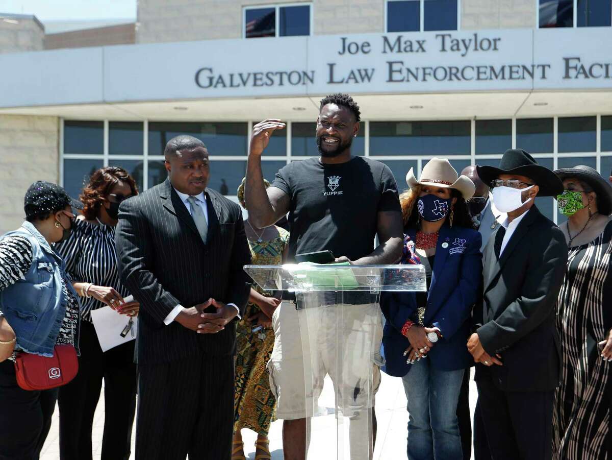 Andre Malone, a man who was tased and arrested during the recent Slab beach party in Galveston, is surrounded by Dr. Candice Matthews, TCBD Accountability Statewide/Harris County Chair, and Quanell X, during a press conference at the Galveston Police Department, Wednesday, May 5, 2021, in Galveston. The Texas Coalition Of Black Democrats organized a “call to action” press conference in response to a Galveston police officer caught on camera wearing a white supremacist mask while In uniform.