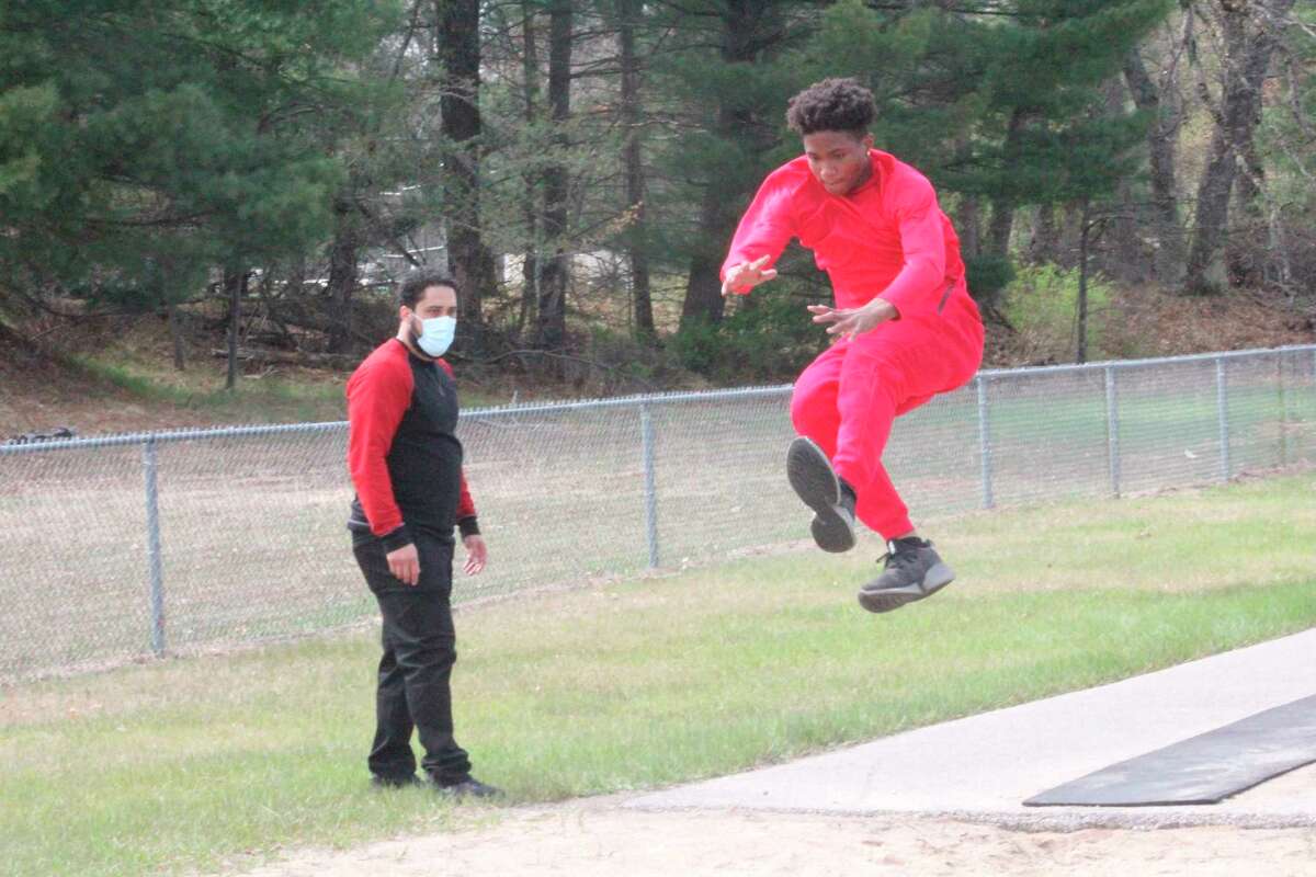 Baldwin junior high coach Nate Fricke watches as Delante Williams flies through the air during a practice last week. ((Star photo/John Raffel)