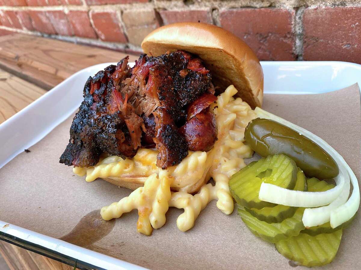 The Brass Monkey sandwich includes chopped brisket, sausage and queso mac at Burnt Bean Co. barbecue restaurant in Seguin.