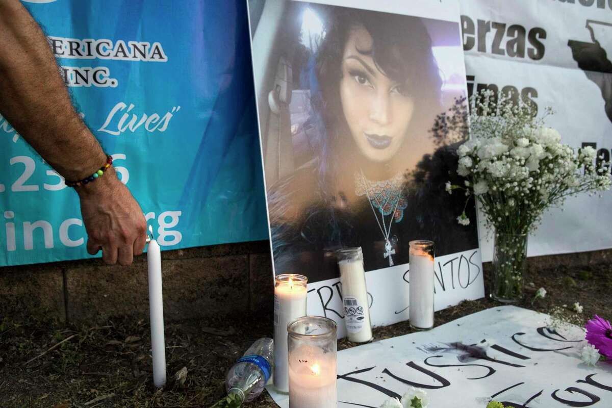 A photo of of Iris Santos, a transgender woman shot to death outside a Chick-Fil-A restaurant two weeks ago is surrounded by candles as friends and family hold a vigil for her Wednesday, May 5, 2021 in Houston. Santos was fatally shot as she sat at a picnic table outside the fast food restaurant around 9:32 p.m. April 23 in the 8600 block of Westheimer Road. A manager found Santos on the north side of the restaurant. Police are still searching for a suspect in the case.