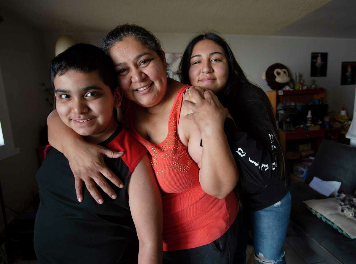 Patricia Mendoza and her children Erik Martinez, 10, left, and Alejandra Mendoza, 18, pose at their apartment in Imperial Beach, Calif., on April 25, 2021,