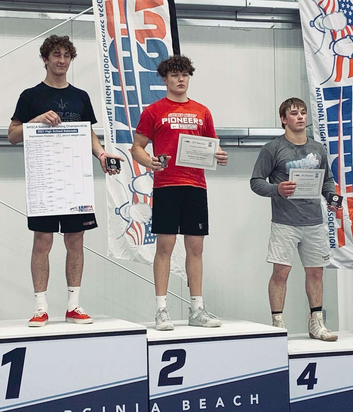 Norwalk's Brendan Gilchrist (center) stands on the podium after his runner-up finish in the sophomore 195-pound weight class at the National High School Coaches Association wrestling tournament in Virginia Beach, Va., on April 25, 2021. Sonny Sasso (PA) was first and Jacob Scheib (PA) was fourth.