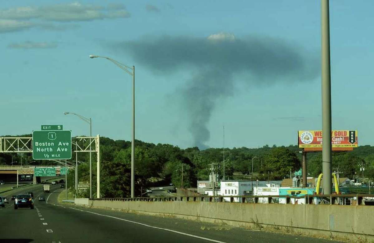A fire swept through and destroyed the former Housatonic Wire Company building along River Street in downtown Seymour on Saturday September 11, 2010. The smoke towered into the sky and could be seen as far away as Bridgeport, as seen here from Route 8 in the city.