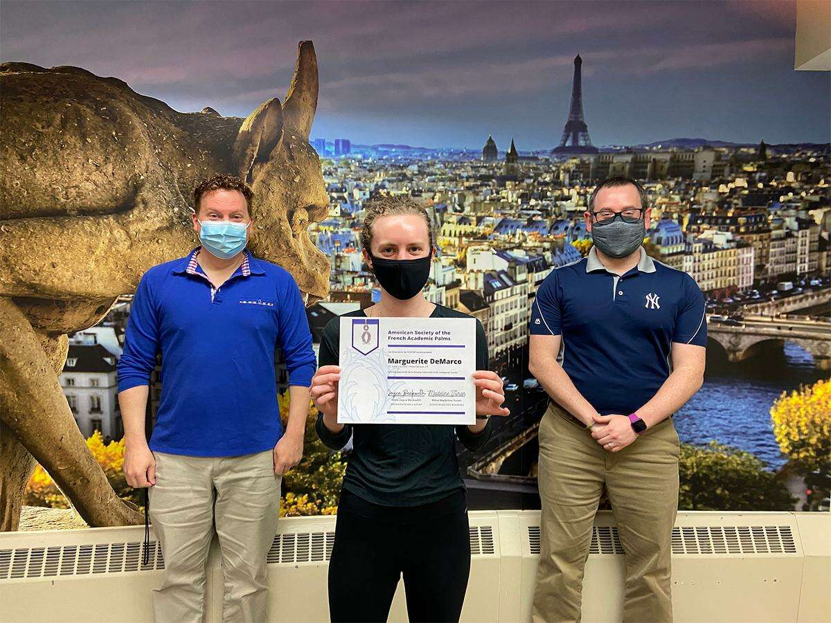 St. Luke's School student, and American Society of the French Academic Palms Scholarship Recipient Marguerite DeMarco, from the St. Luke's School Class of 2021, is pictured with St. Luke's School's Upper School World Language Department Chair, and French Teacher Jon Shee, (left), and Upper School French teacher Evan Downey, (right). St. Luke' School is located at 377 N. Wilton Road in New Canaan.