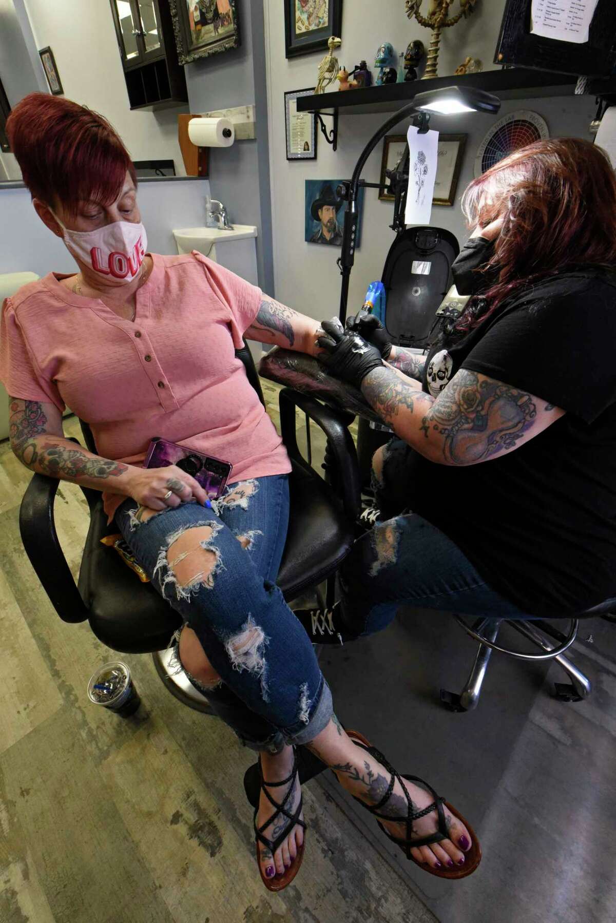 Ann Palmer is seen tattooing her client Debbie Johnson of Cohoes at Darkwater Tattoo on Thursday, May 6, 2021 in Schenectady, N.Y. (Lori Van Buren/Times Union)