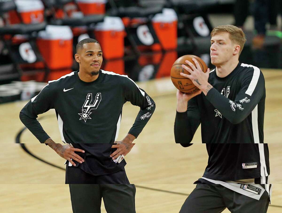 Before the start of the game Dejounte Murray, left, of the Spurs watches Luka Samanic take a shot on Saturday, April 3, 2021, at the AT&T Center
