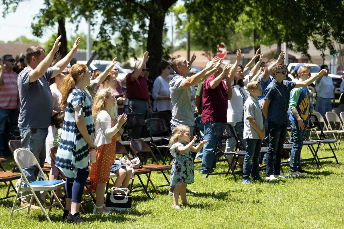 Dozens of attendees participate in a prayer during a National Day of Prayer celebration behind Montgomery County Justice of Peace Precinct 1, Thursday, May 6, 2021, in Willis. Local faith leaders and politicians spoke at this year's event.