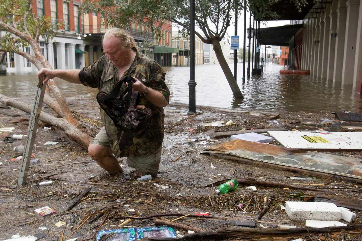 Tom LeCroy walks through debris strewn in The Strand that suffered flooding in the aftermath of Hurricane Ike Saturday, Sept. 13, 2008, in Galveston, Texas. LeCroy's, who rode out the storm in The Strand, restaurant suffered major flood damage.