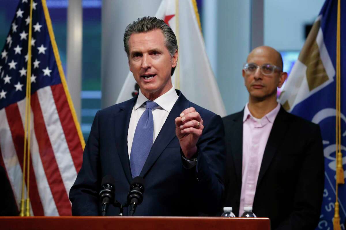 California Gov. Gavin Newsom appears at a press conference on the state's coronavirus response with California Health and Human Services Agency Director Dr. Mark Ghaly on March 17, 2020. On Monday, Newsom announced he’s winding down several COVID emergency orders.