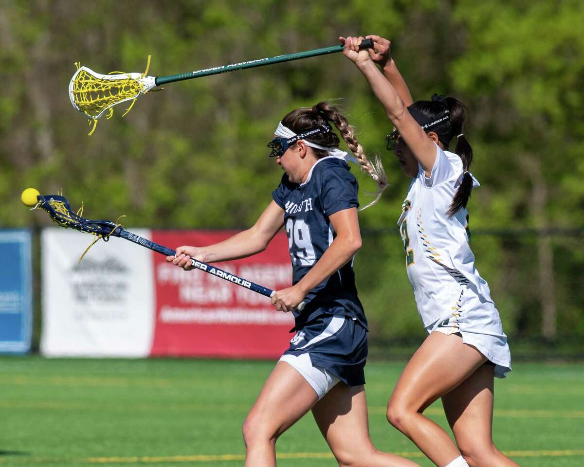 Siena College senior Julia Pelcher reaches over the top of Monmouth University fifth year student Allison Turturro during the MAAC semifinals on Thursday, May 6, 2021. Monmouth is leaving the MAAC for the CAA.