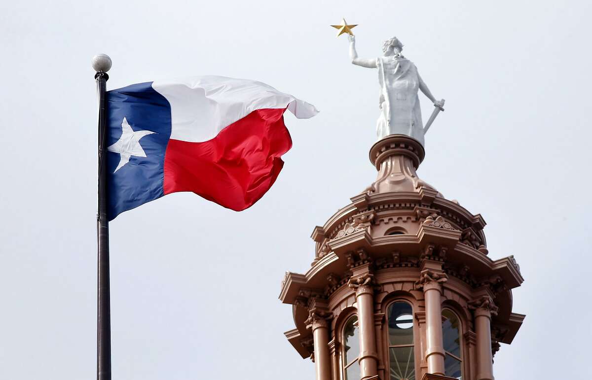 The Texas flag flies over the state Capitol in Austin in 2019. (Tom Fox/The Dallas Morning News/TNS)