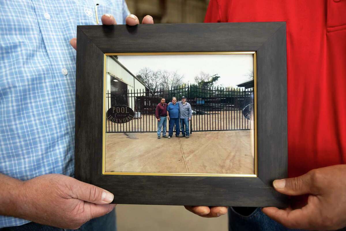 A photo of current co-owners, Dusty Adams, right and Freddy Betancourt, left with past owner, Mr. Pool, is seen at Pool Custom Ironworks, Wednesday, May 5, 2021, in Conroe. The company will be celebrating it's 50th anniversary of opening this Saturday.