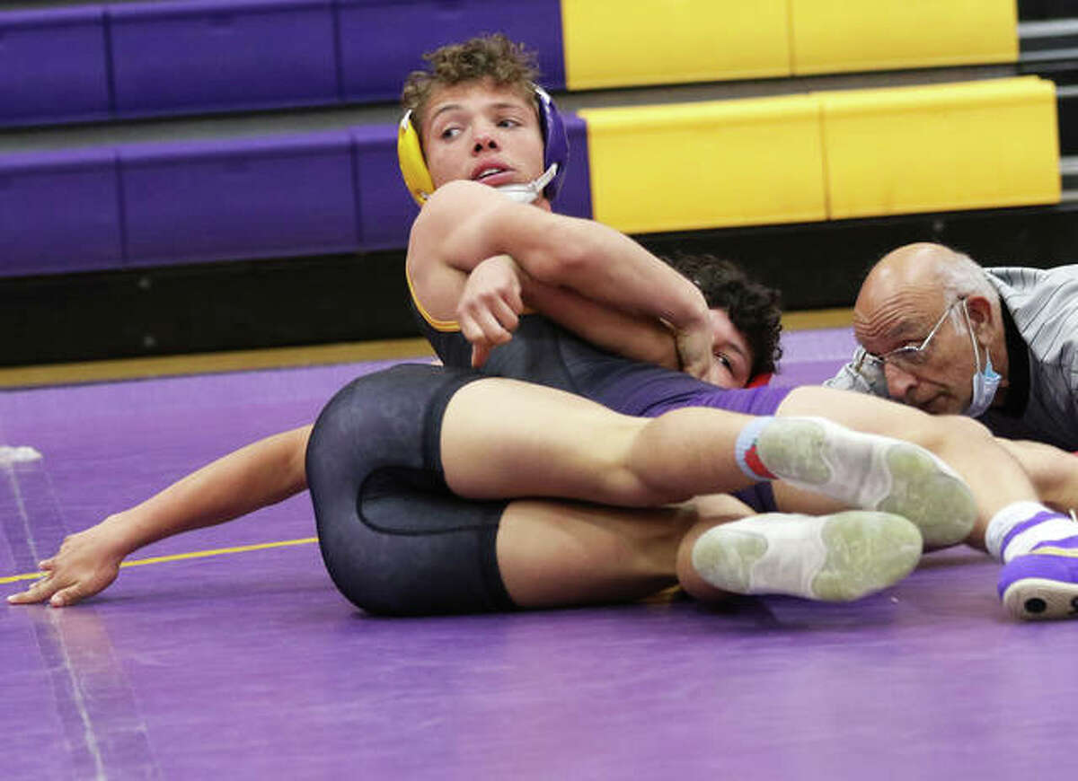 CM’s Caleb Tyus (top) looks back to get instructions from his coach while working over Roxana’s Bryan Rodriguez in a 138-pount match Thursday in Bethalto. Tyus won by pin.