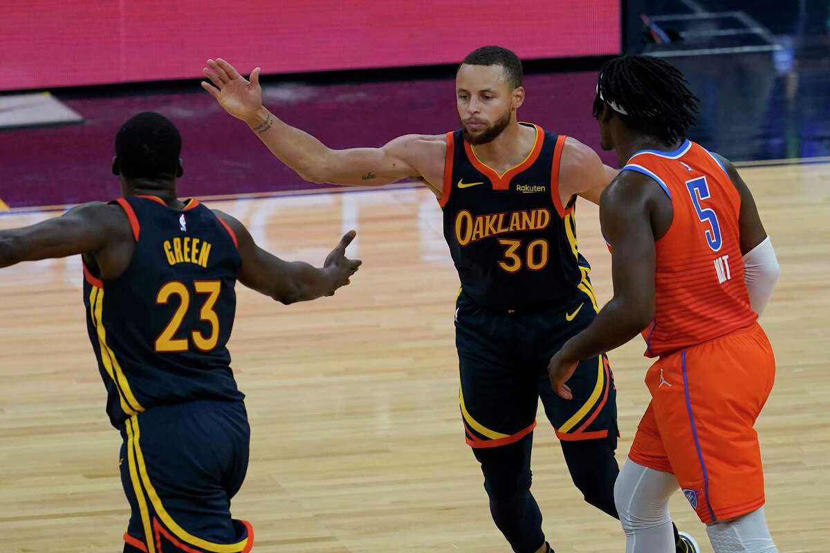 Golden State Warriors forward Draymond Green, left, and guard Stephen Curry celebrate next to Oklahoma City Thunder forward Luguentz Dort during the second half of an NBA basketball game in San Francisco, Thursday, May 6, 2021.
