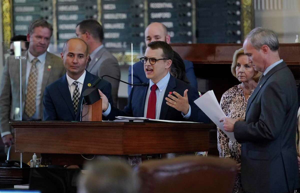Rep. Briscoe Cain, R-Houston, center, stands with co-sponsors as he answers questions and speaks in favor of HB 6, an election bill, in the House Chamber at the Texas Capitol in Austin, Texas, Thursday, May 6, 2021. (AP Photo/Eric Gay)