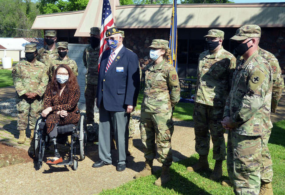 FILE - U.S. Sen. Tammy Duckworth poses for a photo with members of the Illinois National Guard during a COVID-19 vaccine clinic at Edwardsville American Legion Post 199.