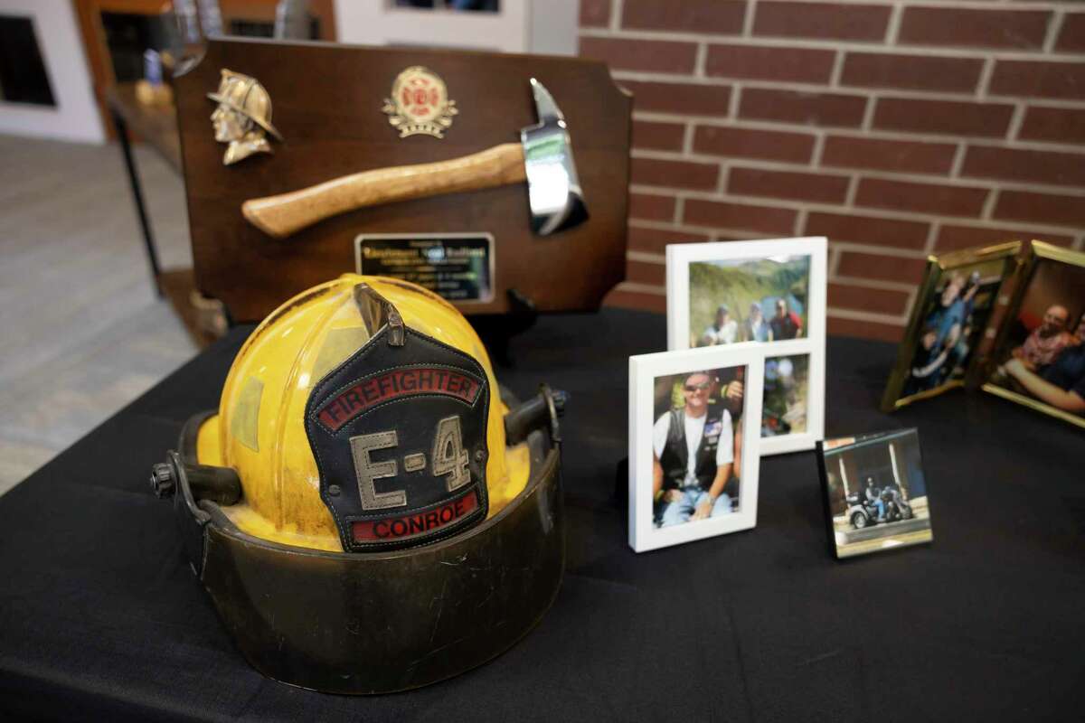 A table filled with images and firefighter items are seen during a funeral service for retired Conroe firefighter Lt. Neal Radford at First Methodist Conroe, Friday, May 7, 2021, in Conroe. Radford died April 29 after a near month-long ICU battle with COVID-19.
