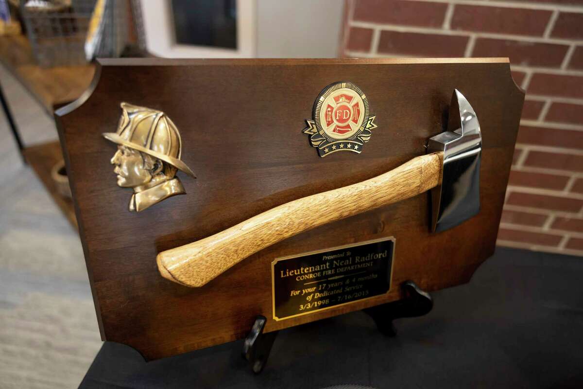 An axe that was presented to retired Conroe firefighter Lt. Neal Radford is seen during a funeral service at First Methodist Conroe, Friday, May 7, 2021, in Conroe. Radford died April 29 after a near month-long ICU battle with COVID-19.