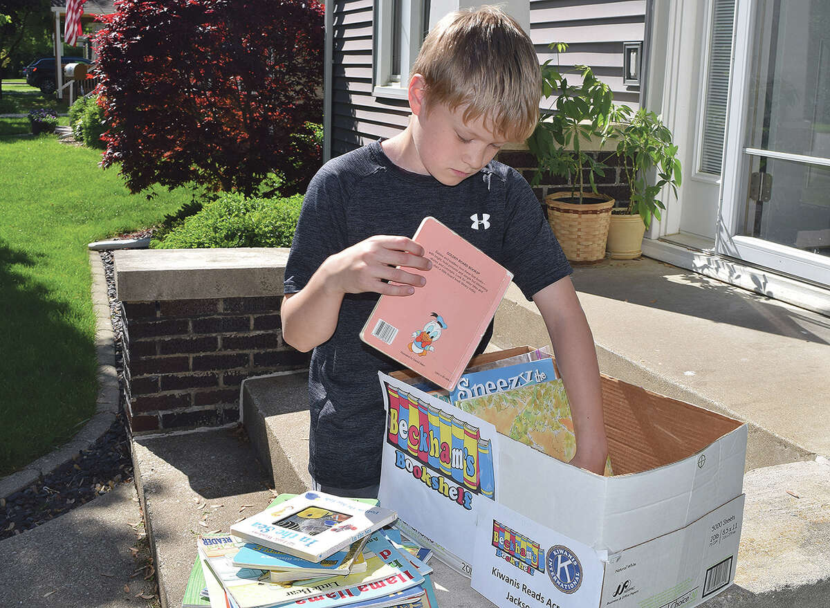 Beckham Oldenettel, 9, of Jacksonville organizes books that were donated to his foundation, Beckham’s Book Shelf. The books will be donated to Jacksonville School District 117 students in kindergarten through fifth grade as part of Kiwanis Club of Jacksonville’s Read Across Jacksonville. 