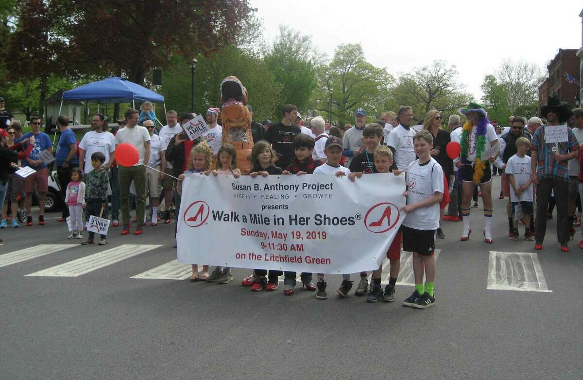 A group of children lead participants of the Walk a Mile in Her Shoes fundraiser and awareness event,held Sunday, May 19, 2019 on the Litchfield Green. This year’s walk is virtual and starts May 17; teams and individuals are encouraged to sign up now.