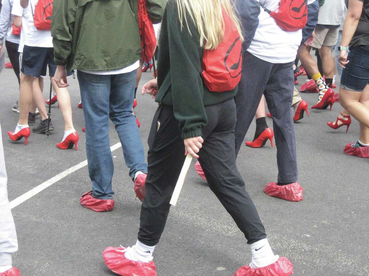 Participants in the Walk a Mile in Her Shoes fundraiser and awareness event show their red shoes May 19, 2019 on the Litchfield Green. This year’s walk is virtual and starts May 17; teams and individuals are encouraged to sign up now.