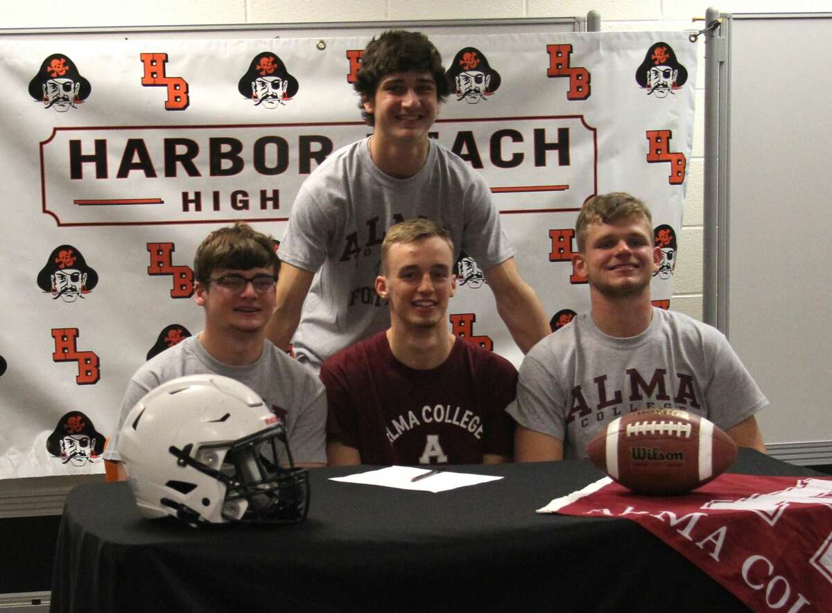 Harbor Beach senior Dylan Kadar, front row, center, signed a letter of intent on Friday morning to attend and play football at Alma College.