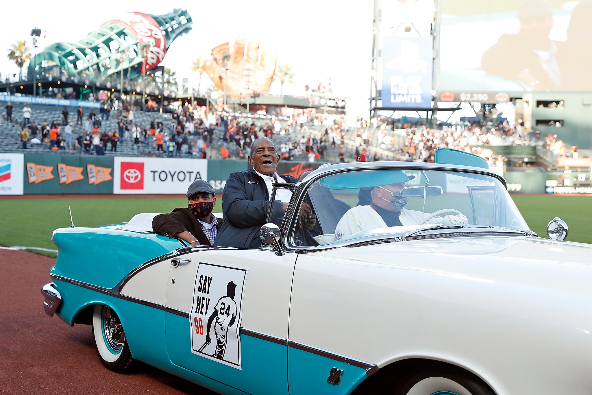 Hall of Fame San Francisco Giants player Willie Mays (L) doffs his