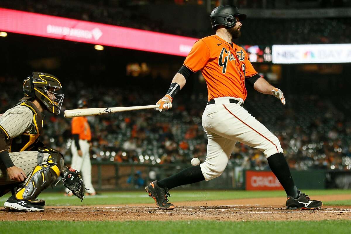 San Francisco Giants first baseman Brandon Belt (9) swings and misses against the San Diego Padres in the fifth inning during an MLB game at Oracle Park, Friday, May 7, 2021, in San Francisco, Calif.