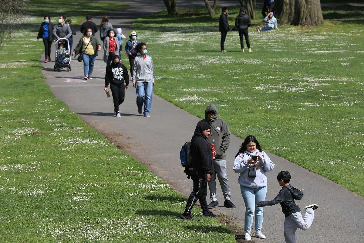 Folks enjoy an afternoon at Golden Gate Park in April. Many who have gone maskless as the CDC guidelines changed have been derided by others.