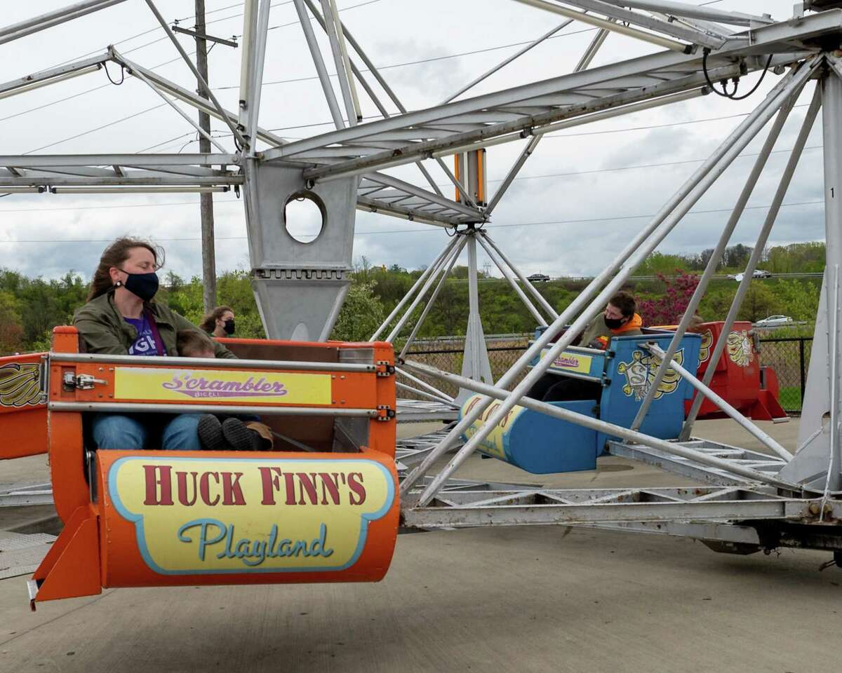 Patrons take a ride on The Scambler during the opening day of Huck Finn’s Playland in Albany, NY, on Saturday, May 8, 2021. It is the first time it has opened since the fall of 2019 because of the pandemic. A development proposal would move the playland closer to the Hudson River and correlate with the refurbishment of Central Warehouse. (Jim Franco/Special to the Times Union)