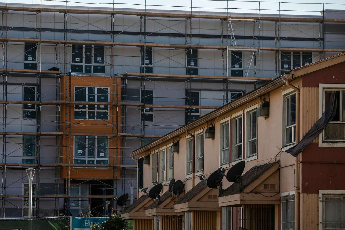 A multi-story housing construction is seen next to the public housing projects in the Sunnydale neighborhood of San Francisco, Calif. May 3, 2021.