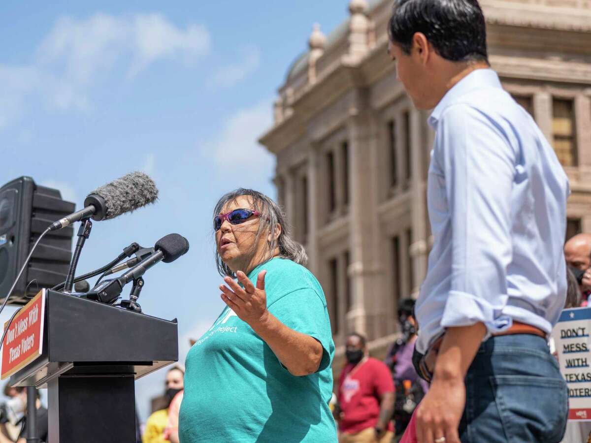 Rosie Castro, civil rights and political activist from San Antonio, left, speaks from the podium alongside her son, Juli‡n Castro, right, former US Secretary of Housing and Urban Development under President Obama, during a voting rights rally at the Texas State Capitol in Austin, Tx., U.S. on Saturday, May 8, 2021. The rally was held in response to a number of bills making their way through the Texas Legislature that critics say would restrict voting access for Texans across the state by shutting down polling places and creating barriers to voting for historically marginalized communities.