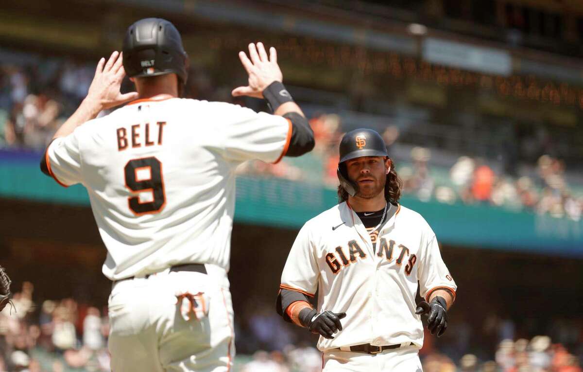 SAN FRANCISCO, CALIFORNIA - MAY 08: Brandon Crawford #35 of the San Francisco Giants is congratulated by Brandon Belt #9 after he hit a three-run home run in the second inning against the San Diego Padres at Oracle Park on May 08, 2021 in San Francisco, California. (Photo by Ezra Shaw/Getty Images)