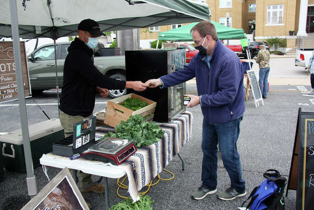 The Goshen Winter Market will be open in the expansion parking lot on St. Louis St. from 10 - noon. Pictured Robert Wolff, left, with Rustic Roots of Brighton, gives a customer his change just before the customer takes a dozen eggs from the portable refrigerator in the background.