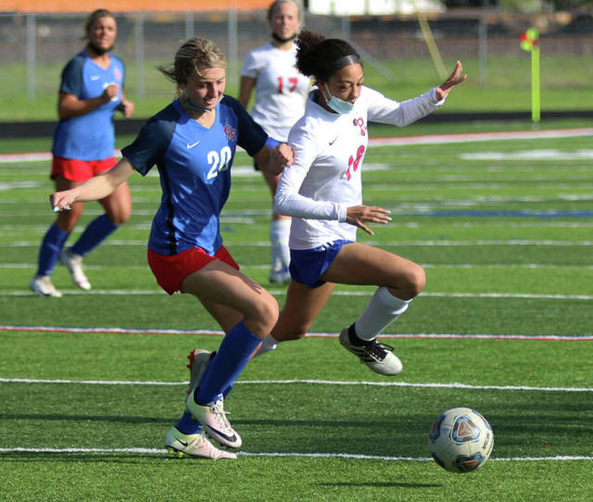Roxana’s Jada Covington (right) competes with Carlinville’s Jill Stayton for ball during an April 29 match in Carlinville. On Saturday in Belleville, Covington scored a goal to help the Shells stay unbeaten with a 3-0 win over Highland in the Metro Cup.