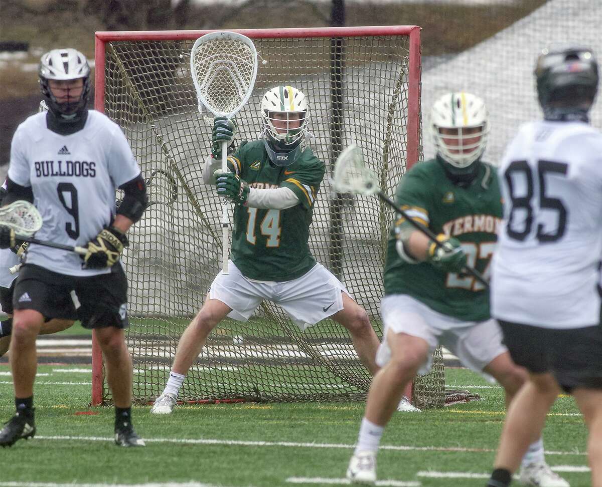 Vermont goalie Ryan Cornell (14) of Darien in action for the Catamounts during a men's lacrosse game against Bryant University on Feb. 27, 2021.