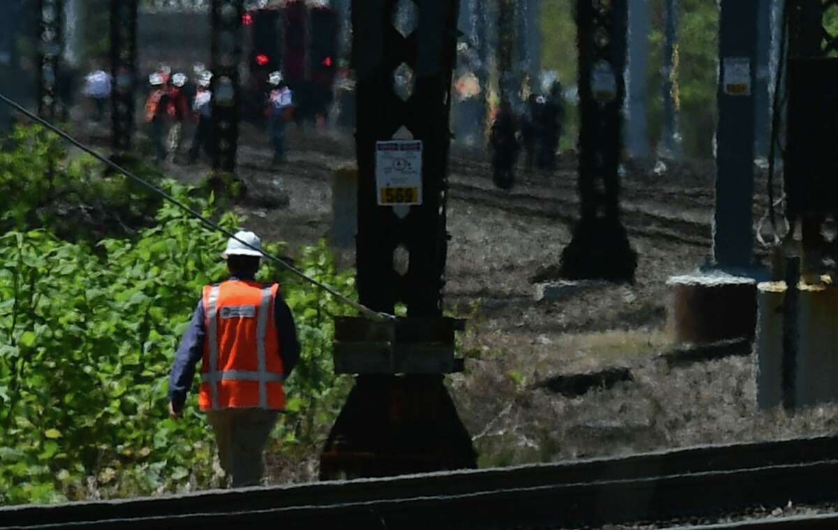 Emergency personnel and Metro North employees respond to the scene of a train accident Thursday May 6, 2021, in Norwalk, Conn.