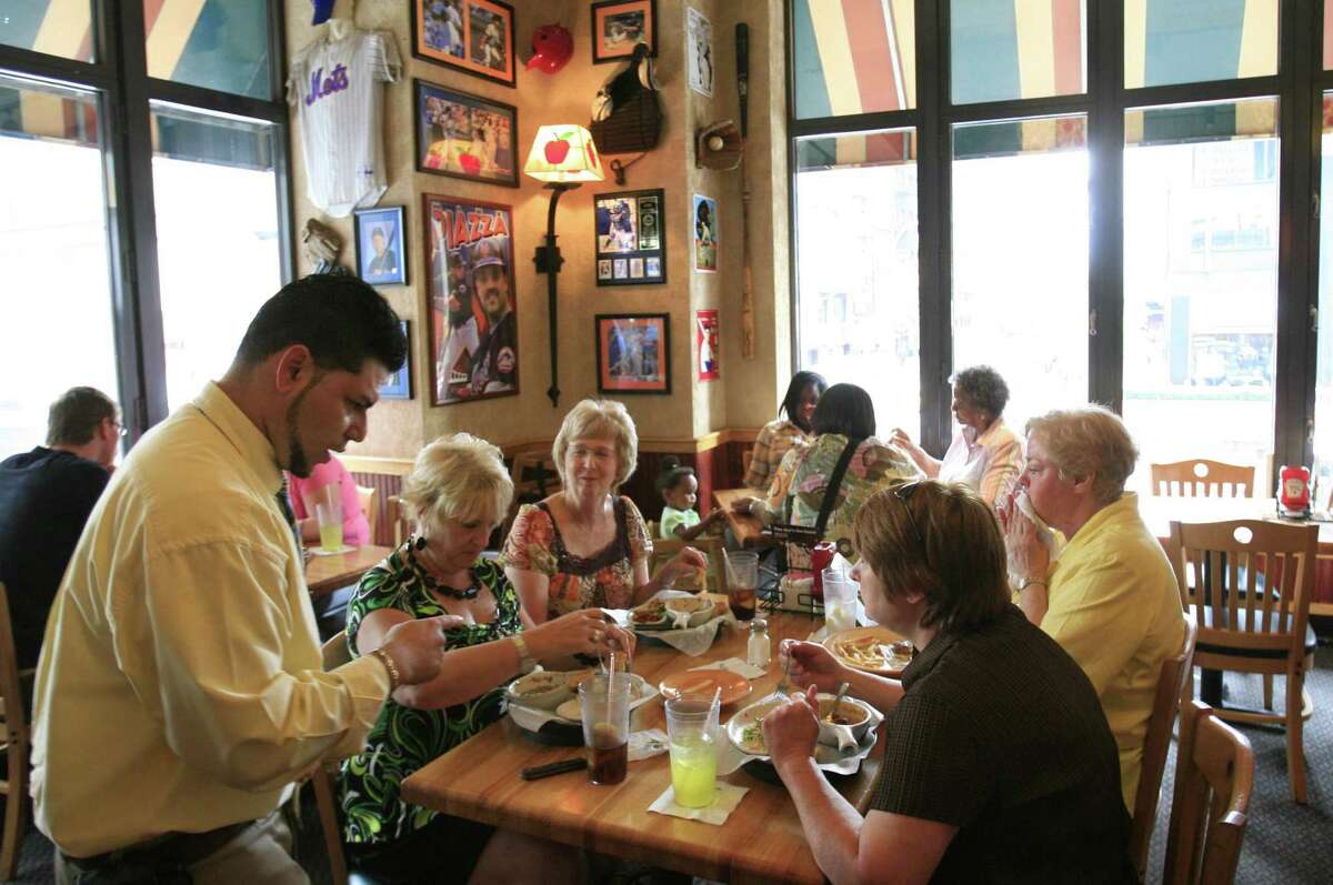 In a file photo, customers enjoy lunch at an Applebee's Neighborhood Grill & Bar in New York.