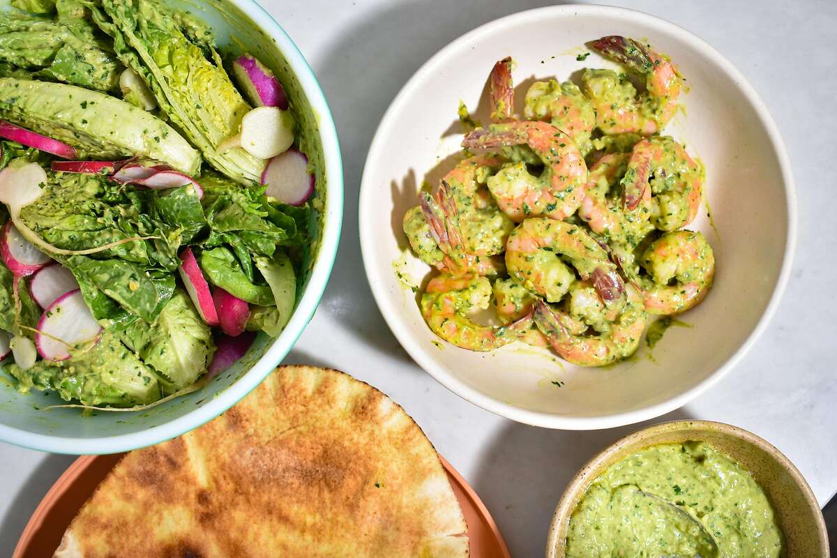 Shrimp, leafy herbs and lettuces provide a fresh base for avocado-pistachio dressing.