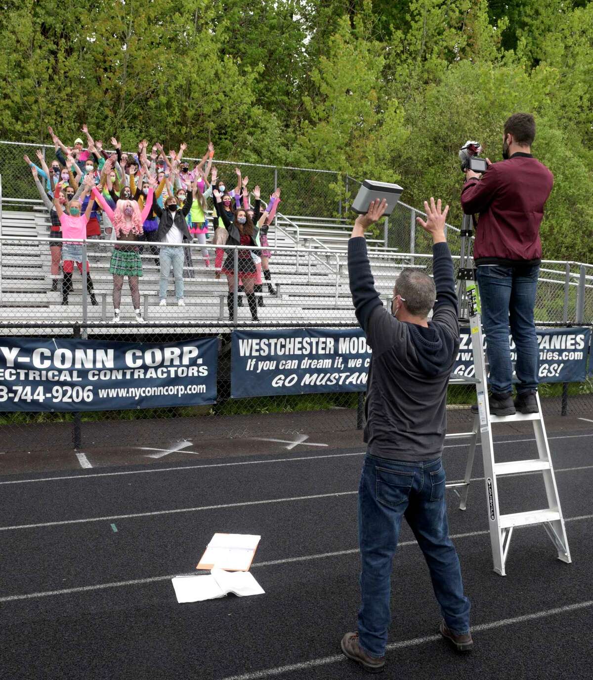 Matthew Farina, director and choreographer, directs students in the Immaculate High School video production of