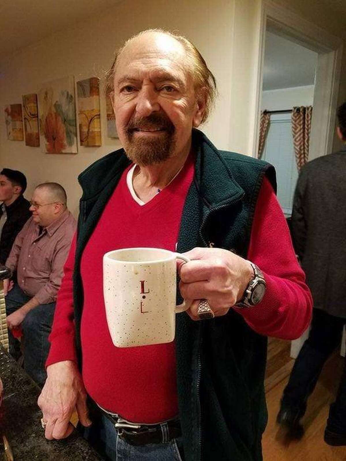 Larry LaConte shows off his personalized coffee mug during a meeting of the Trumbull Rotary.