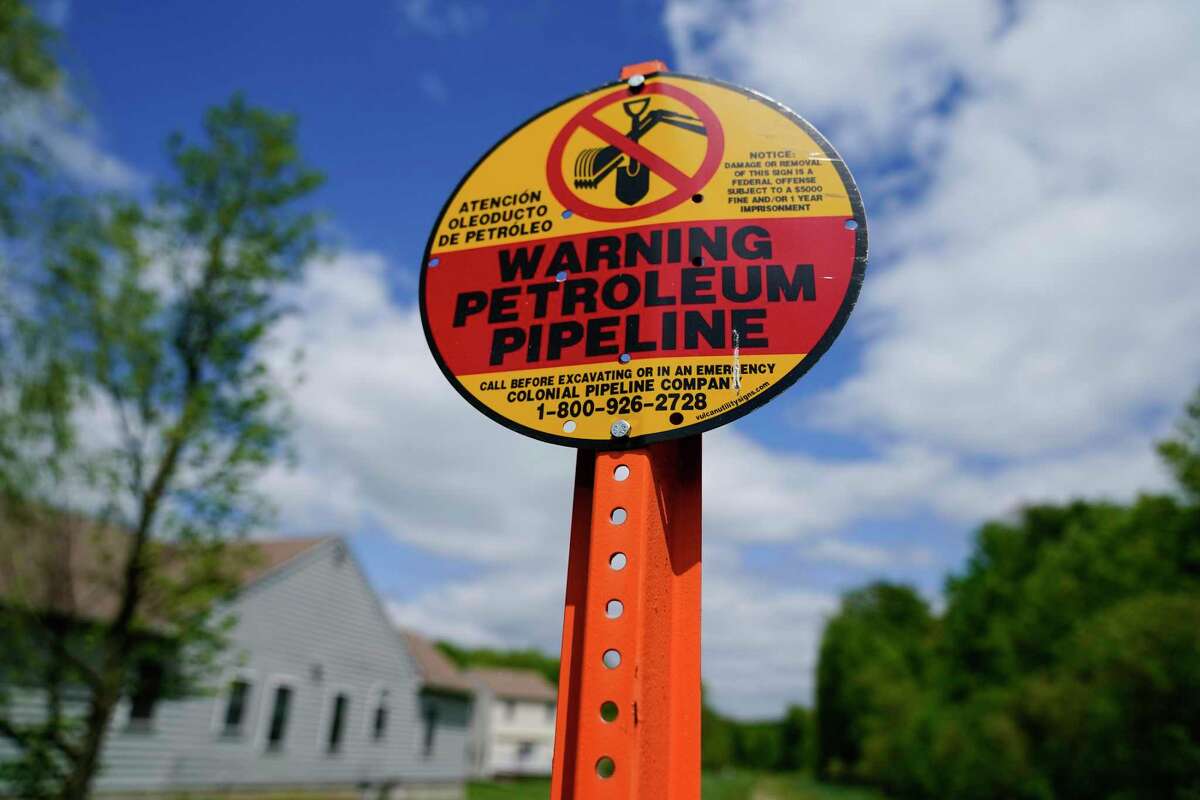 A warning sign is posted along the path of the Colonial Pipeline in Garnet Valley, Pa., Monday, May 10, 2021. Gasoline futures are ticking higher following a cyberextortion attempt on the Colonial Pipeline, a vital U.S. pipeline that carries fuel from the Gulf Coast to the Northeast. (AP Photo/Matt Rourke)