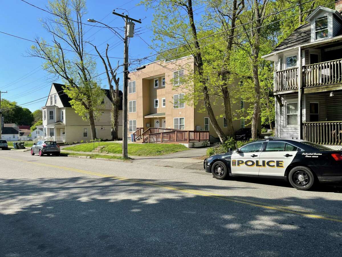 A police cruiser seen on McKinley Avenue in Norwich, Conn., on May 11, 2021, after police say a 1-month-old child was killed Monday night when he was attacked by the family dog inside their apartment (center).
