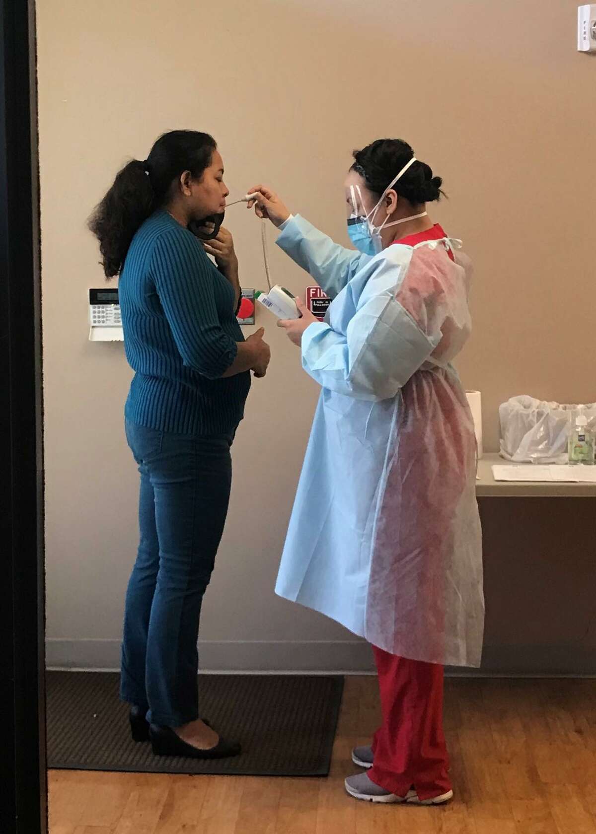 TOMAGWA HealthCare Ministries celebrated Nurses Week, May 6-12, by decorating their locations, passing out treats, fun tumblers, decorated cookies, and sharing words of thanks for the blessing that their nurses are. Pictured is MA Helen Saenz-Camacho taking temperature.