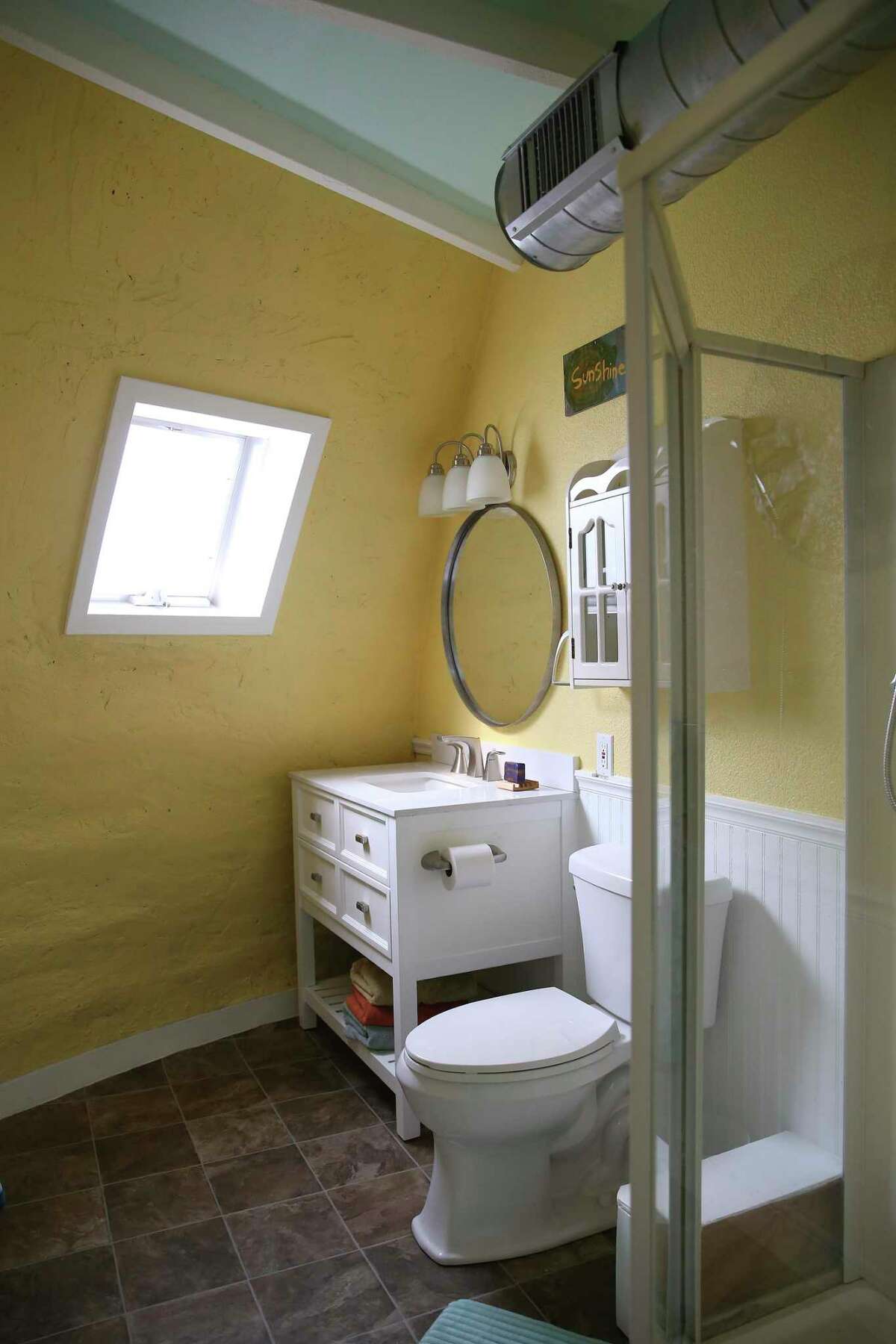 A view of a downstairs bathroom shows how the exterior walls curve inward as they rise up.