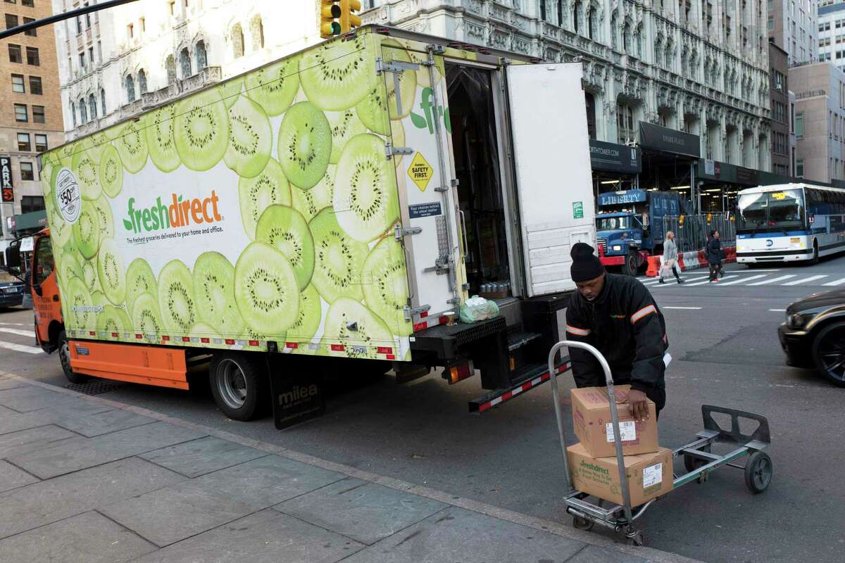 A FreshDirect driver loads boxes into his truck in New York.