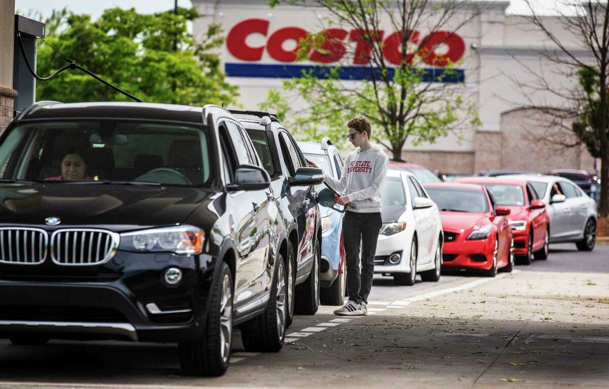 Numerous vehicles line up for gasoline at Costco on Wendover Avenue in Greensboro, N.C., on Tuesday, May 11, 2021. As the shutdown of a major fuel pipeline entered into its fifth day, efforts are under way to stave off potential fuel shortages, though no widespread disruptions were evident. The Colonial Pipeline, which delivers about 45% of the fuel consumed on the East Coast, was hit by a cyberattack on Friday. (Woody Marshall/News & Record via AP)